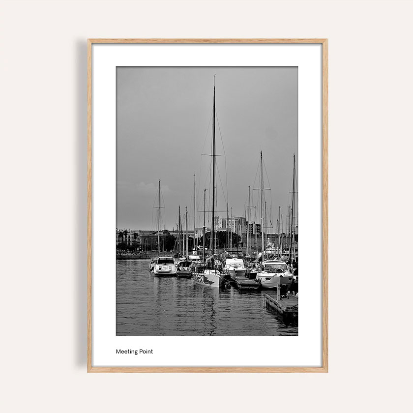 Black and white seascape titled “Meeting Point,” showing boats on calm water with a clear horizon.